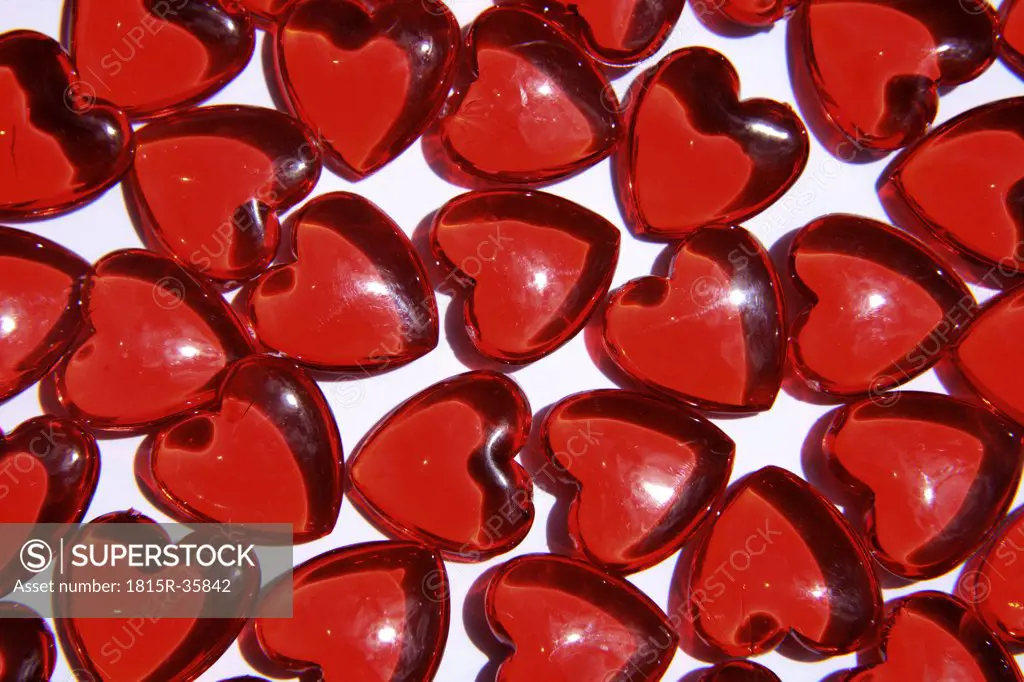 Red heart-shaped glass objects, close-up