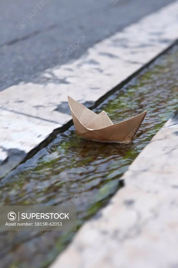 France, Paper Boat floating in gutter