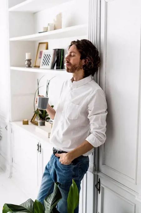 Man having a coffee break at home