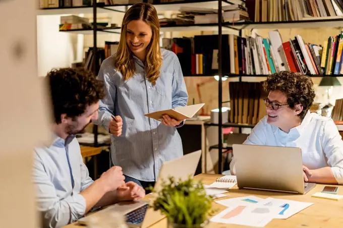 Coworkers working at desk in office