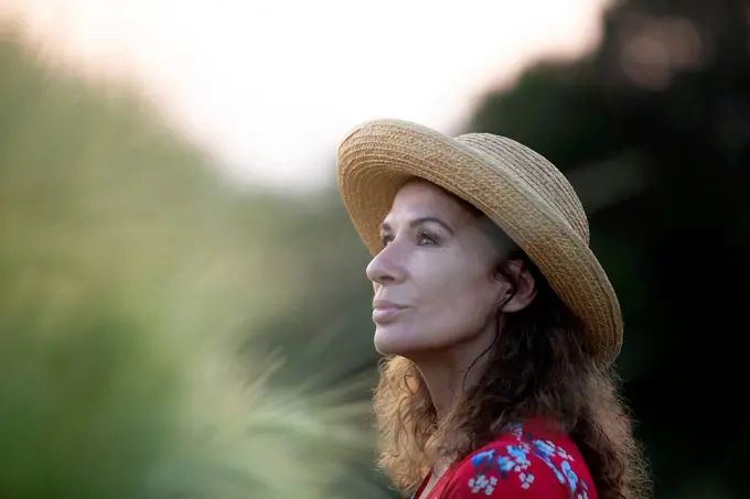 Portrait of woman wearing straw hat in nature