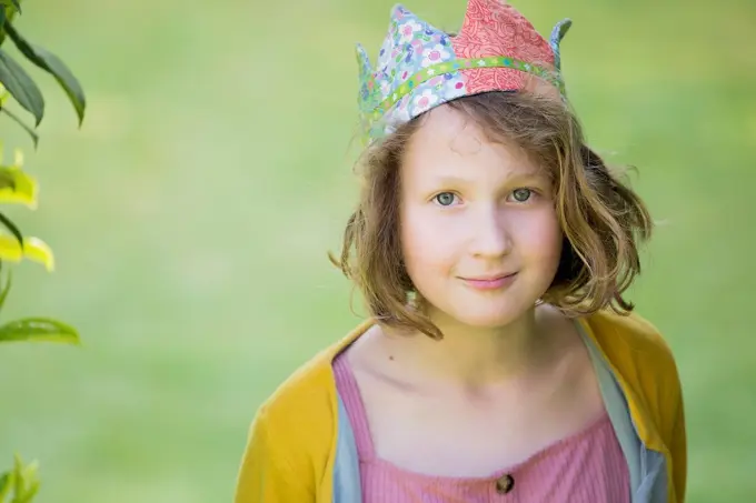 A smiling girl in a handmade crown