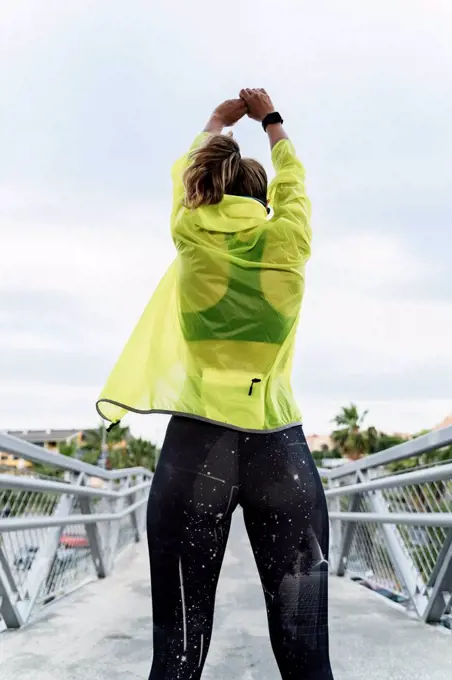 Femal athlete stretching after workout