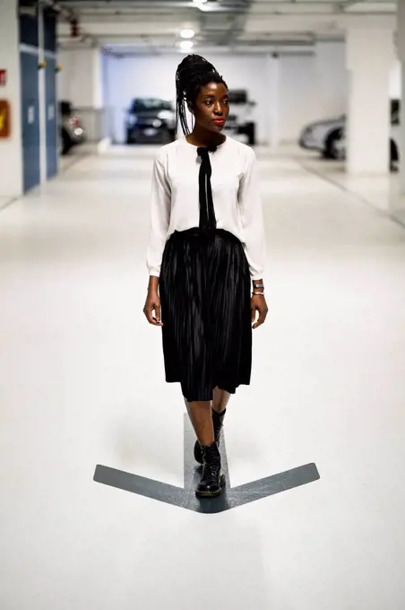 Elegant woman walking in car park