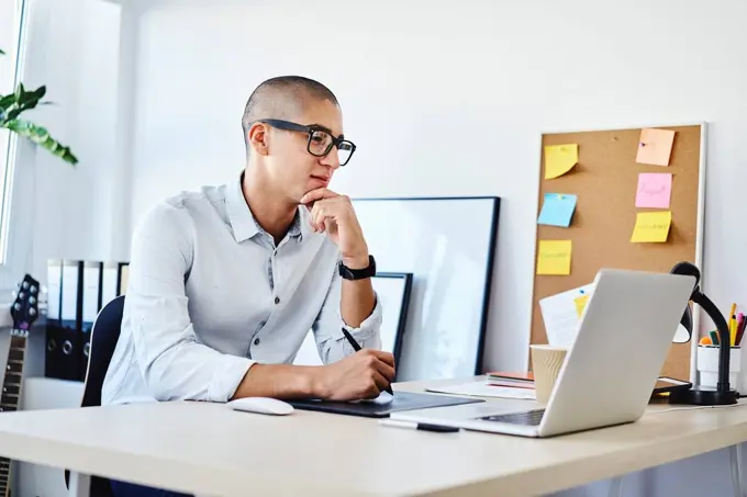 Portrait of graphic designer working in home office