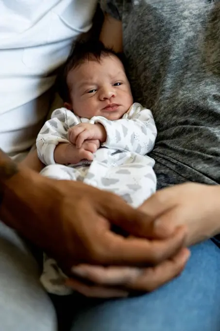 Portrait of newborn baby between his parents