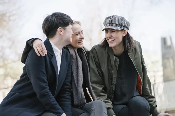 Group of happy young women sitting outdoors