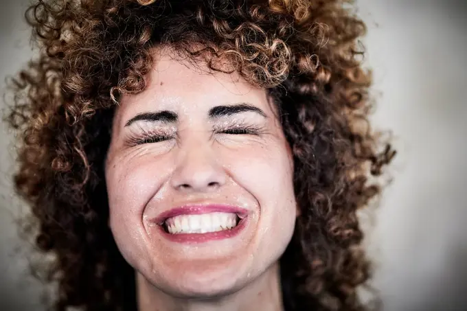 Portrait of sweating woman with curly hair