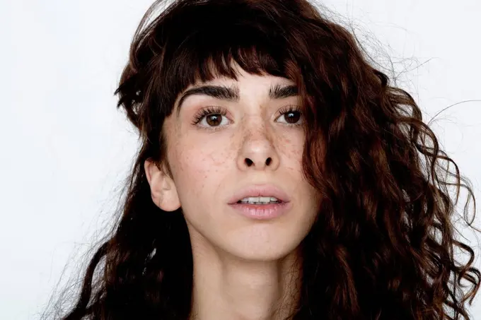 Portrait of young woman with freckles