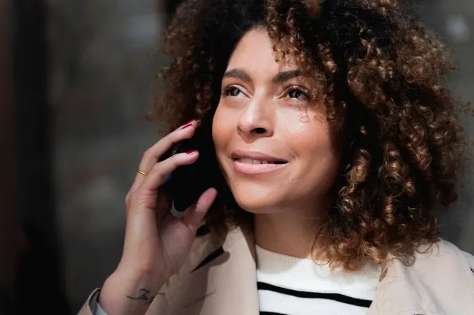 Portrait of smiling woman talking on cell phone