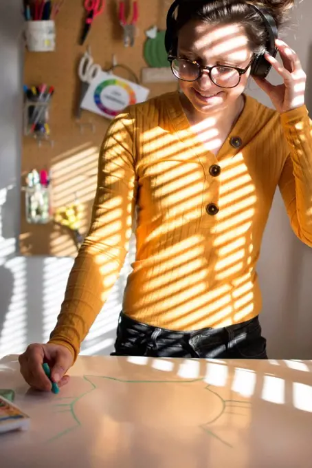 Woman painting and listening to music