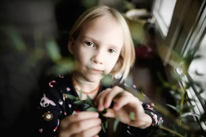 Portrait of blond little girl at home