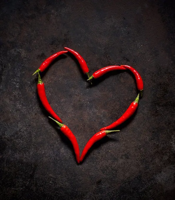 Red chili peppers arranged in heart shape