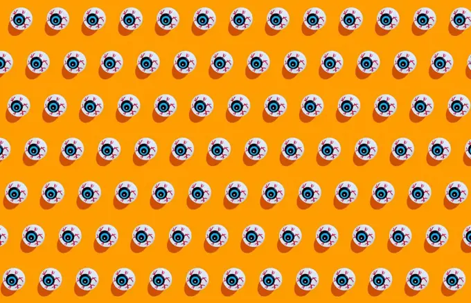 Fake scary eyeballs for halloween on orange background