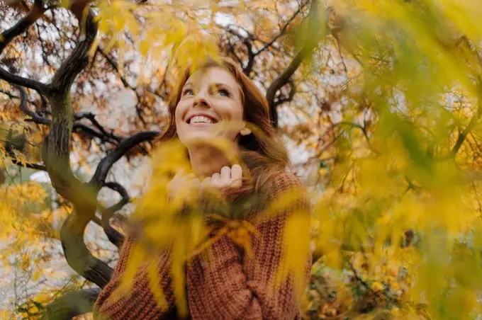 Portrait of a happy woman in autumn