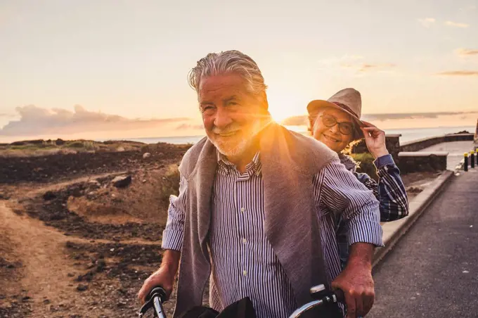 Happy active senior couple on bicycle, Tenerife