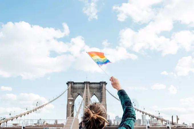 Woman waving LGBT flag in NYC, USA