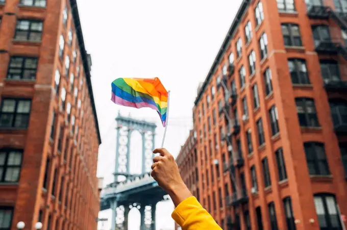 Hand waving LGBT flag in NYC, USA