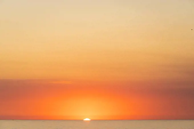 USA, California, Los Angeles, Moody orange sky over Pacific Ocean at sunset