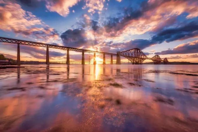 UK, Scotland, South Queensferry, Forth Bridge at dramatic sunset