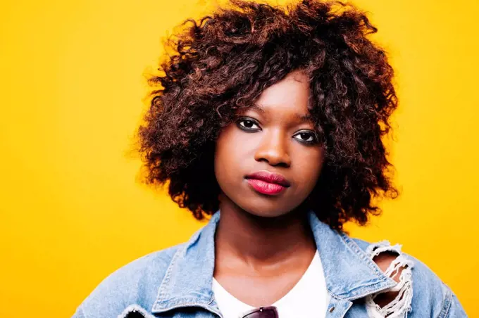 Portrait of beautiful serious young woman in studio