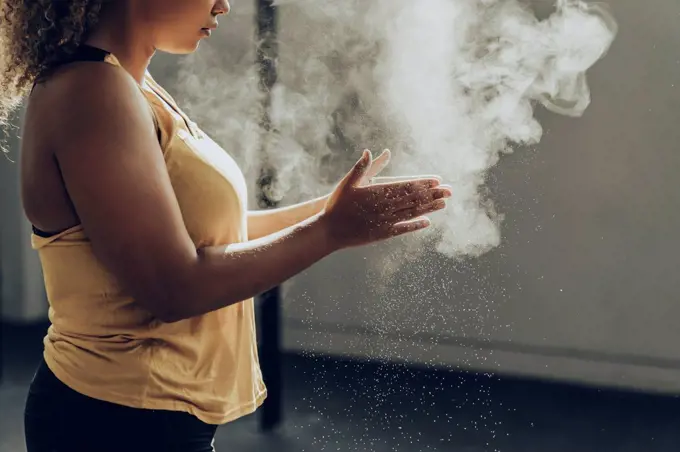 Athletic woman preparing for workout in gym