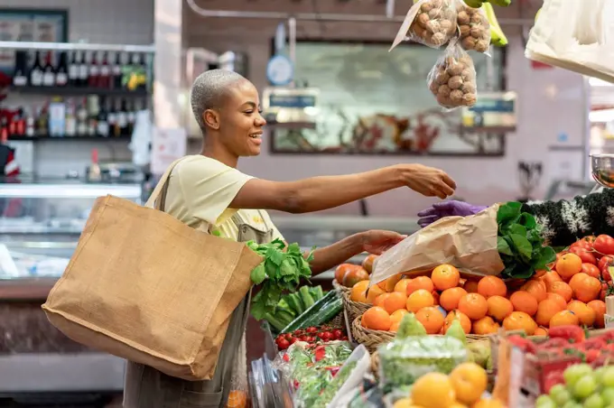 Woman buying groceries in a market hall