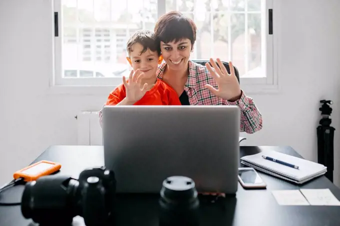 Mother and son using laptop for a video call at home