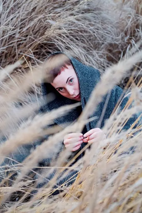 Portrait of young woman among grasses