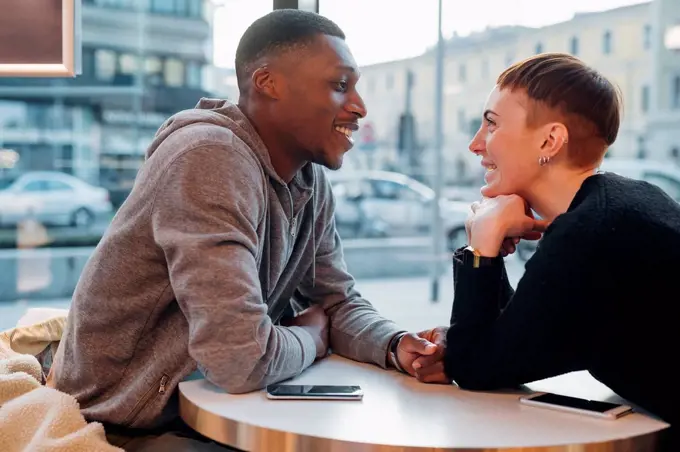 Smiling young couple in a cafe