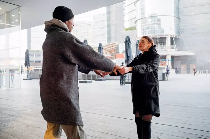 Young couple holding hands in the city