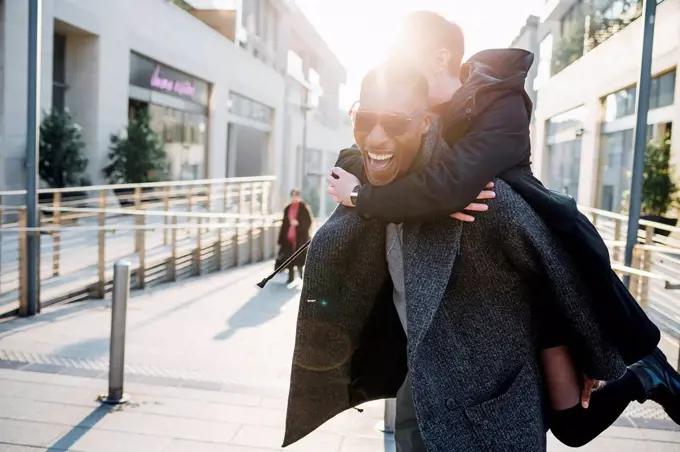 Carefree young couple in the city at sunset