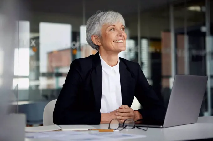 Senior businesswoman at desk in her office