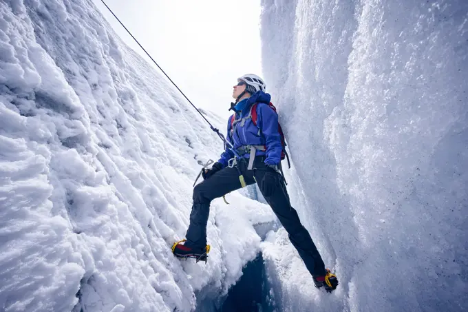 Female mountaineer in crevasse, Glacier Grossvendediger, Tyrol, Austria