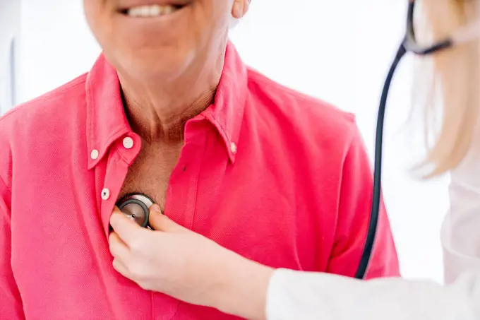 Female doctor examining senior patient in medical clinic