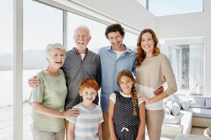 Portrait of happy multi-generation family in luxury villa