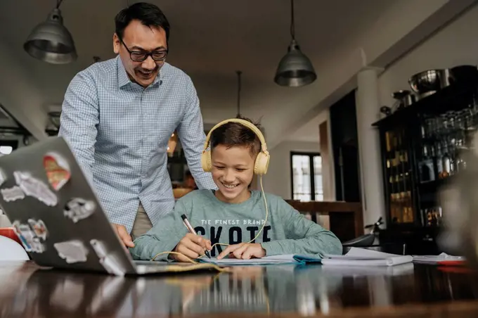 Fatherc helping son with his homework