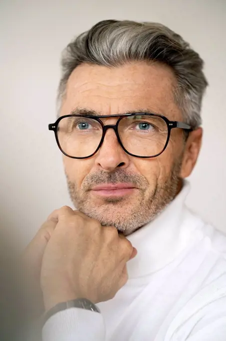 Close-up of thoughtful mature manager wearing eyeglasses in office