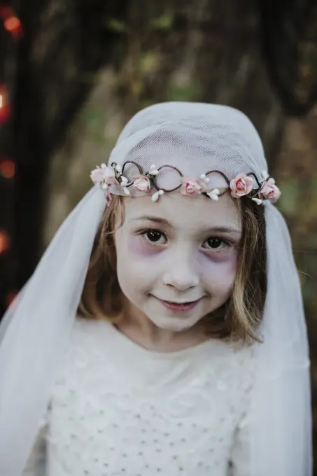 Cute girl wearing costume of corpse bride while standing in forest