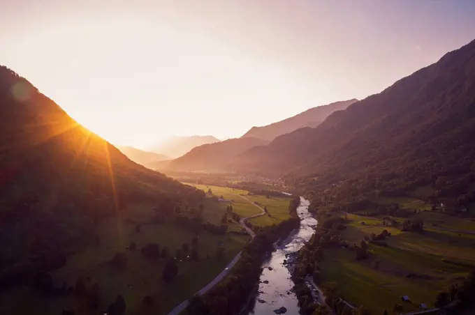 Aerial view of Soca river and mountains against sky during sunset, Gabrje, Slovenia