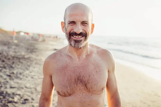 Smiling man standing at beach