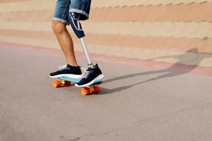 Disabled athlete skateboarding at sports court