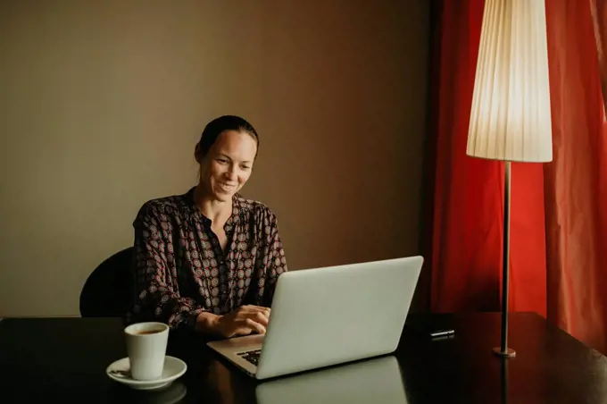 Female entrepreneur smiling while working in office