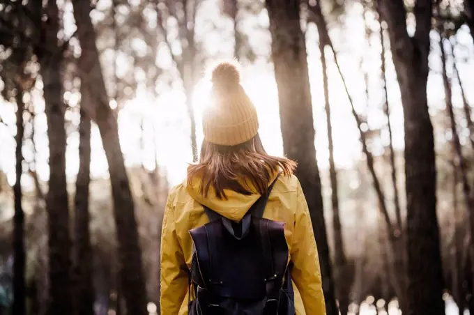 Woman with backpack exploring in forest