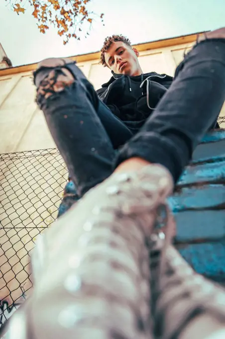 Man sitting on graffiti wall