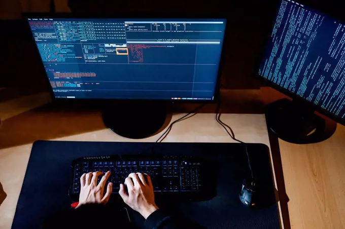 Hacker hands working on computer at office