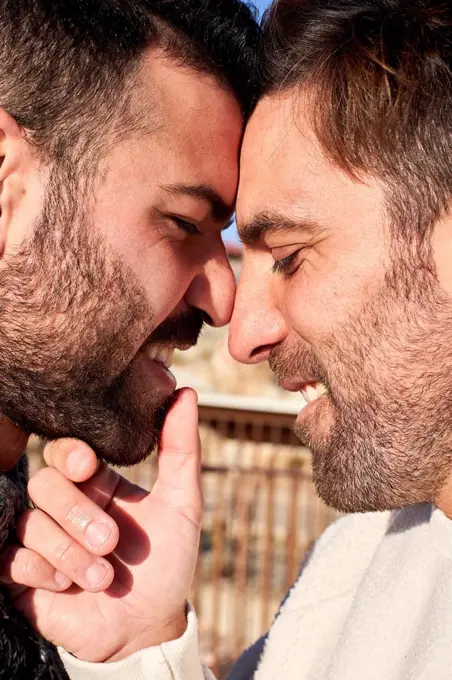 Close-up of romantic gay men with face to face