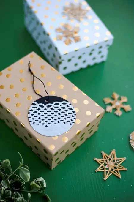 Wrapped Christmas present and name tag made of doily