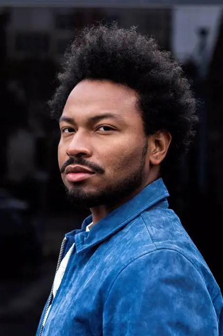 Close-up portrait of serious stylish man with afro hair