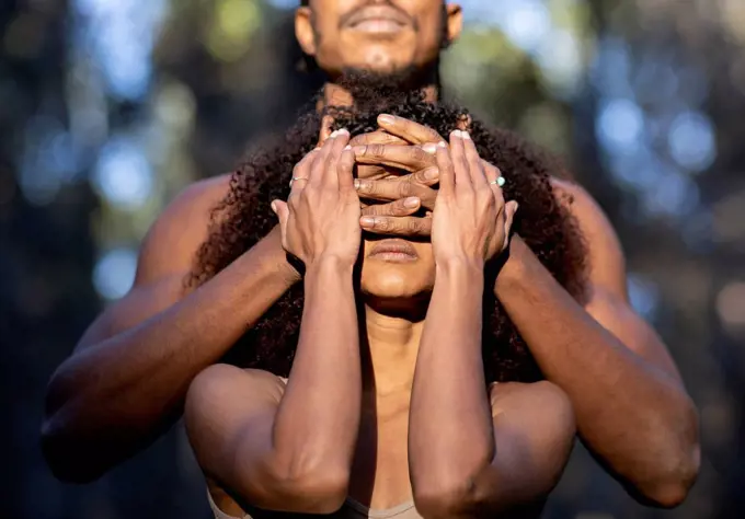 Male dancer covering eyes of female partner during performance